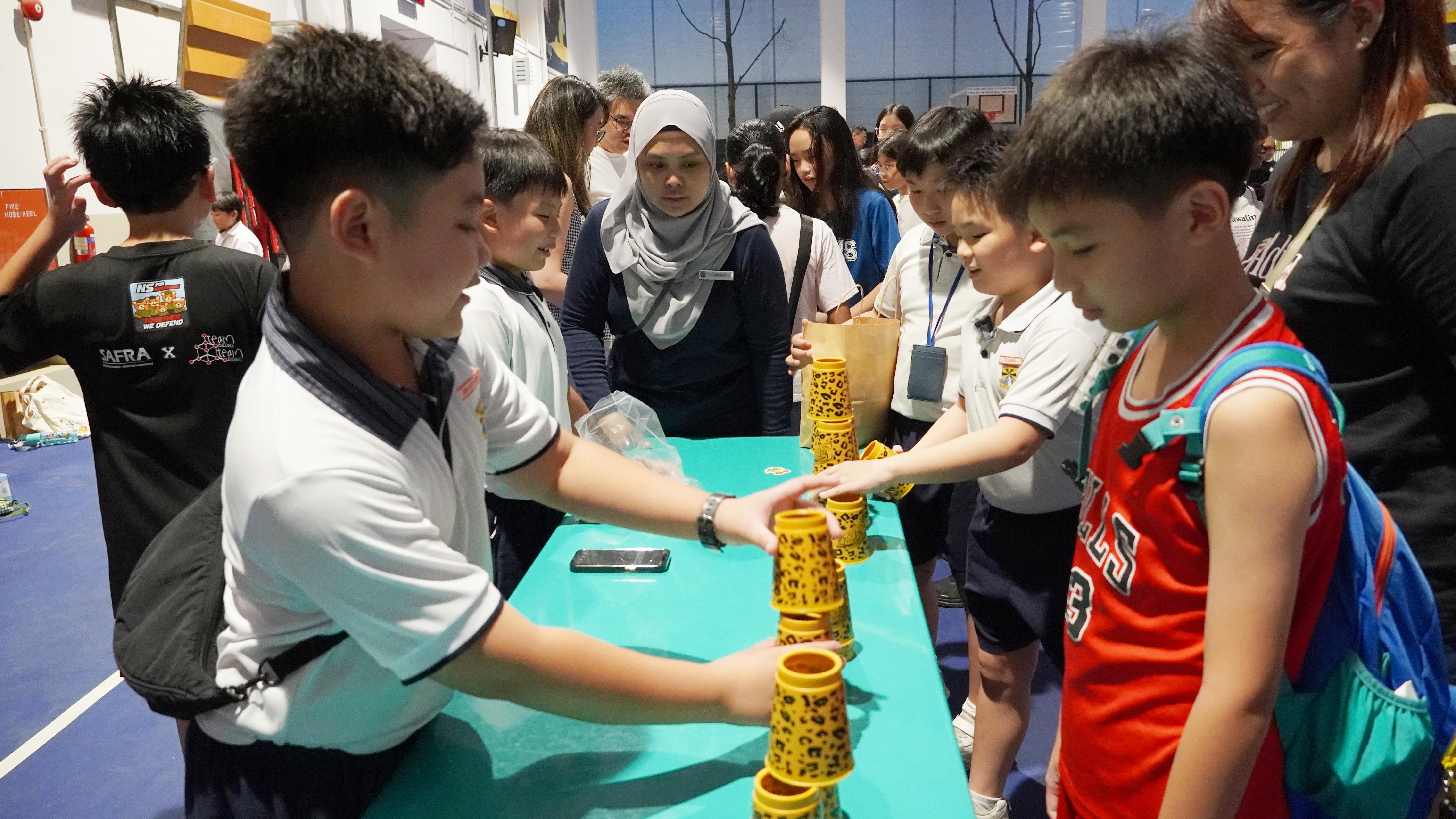 Steady hands and sharp focus! Our pupils put their speed and coordination to the test as they race to stack the cups.